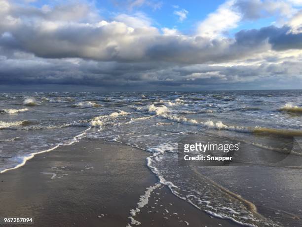 tip of grenen beach where skagerrak and kattegat oceans meet, jutland, denmark - kattegat stock-fotos und bilder