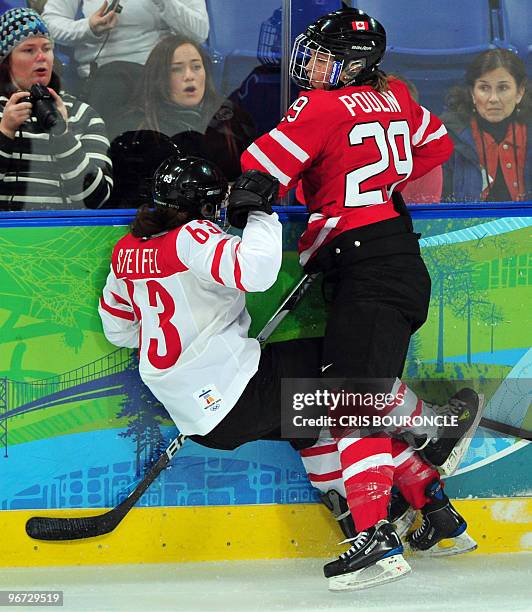Swiss Anja Stiefel collides with Canada's Marie-Philip Puolinduring the Women's Ice Hockey preliminary game between Switzerland and Canada at the UBC...