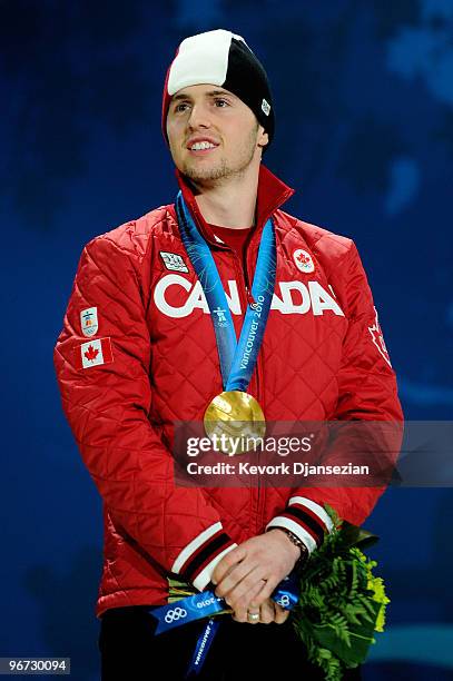 Alexandre Bilodeau of Canada celebrates after receiving the gold medal during the medal ceremony for winning the gold in the Freestyle Skiing Men's...