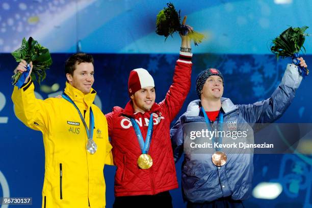 Dale Begg-Smith of Australia celebrates winning silver, Alexandre Bilodeau of Canada poses with the gold and Bryon Wilson of the United States poses...