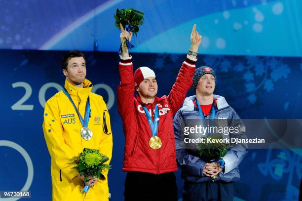 Dale Begg-Smith of Australia celebrates winning silver, Alexandre Bilodeau of Canada poses with the gold and Bryon Wilson of the United States poses...