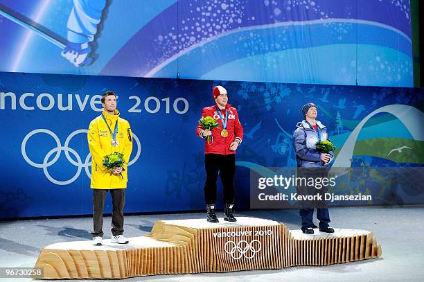 Dale Begg-Smith of Australia celebrates winning silver, Alexandre Bilodeau of Canada poses with the gold and Bryon Wilson of the United States poses...