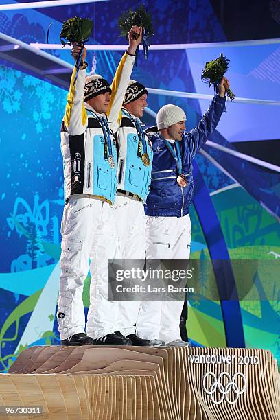 David Moeller of Germany celebrates winning the silver medal, Felix Loch of Germany poses with the gold and Armin Zoeggeler of Italy poses with the...