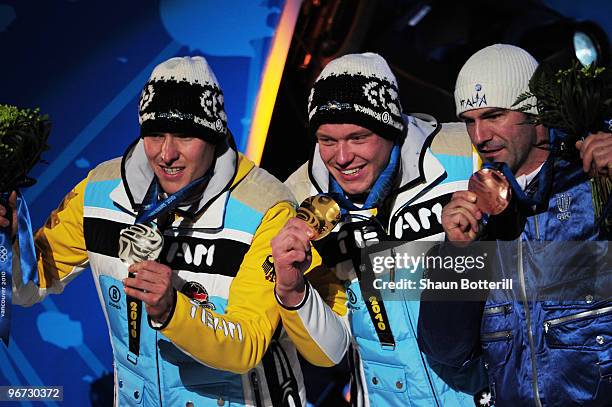 David Moeller of Germany celebrates winning the silver medal, Felix Loch of Germany poses with the gold and Armin Zoeggeler of Italy poses with the...