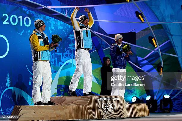 David Moeller of Germany celebrates winning the silver medal, Felix Loch of Germany poses with the gold and Armin Zoeggeler of Italy poses with the...