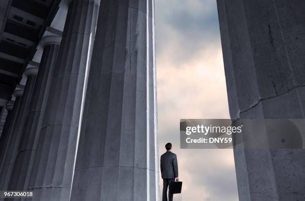 man standing next to columns looks into distance - legal discovery stock pictures, royalty-free photos & images