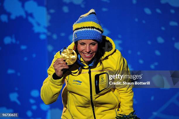 Charlotte Kalla of Sweden celebrates with the gold medal during the medal ceremony for the Cross-Country Skiing Ladies' 10 km Free at Whistler Medals...