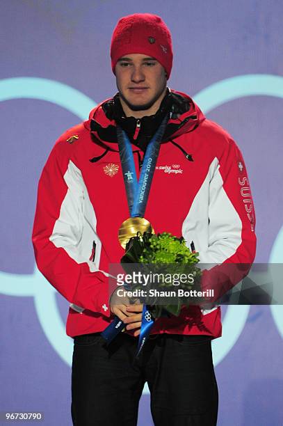 Dario Cologna of Switzerland celebrates with the gold medal during the medal ceremony for the Cross-Country Skiing Men's 15 km Free on day 4 of the...