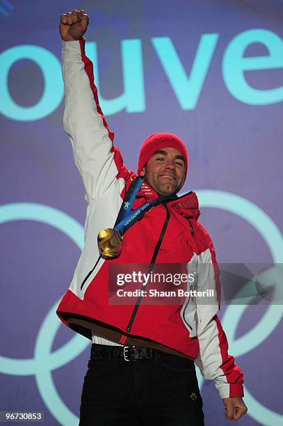 Didier Defago of Switzerland poses with the gold medal at the medal ceremony for the Alpine skiing Men's Downhill at Whistler Medal Plaza during the...