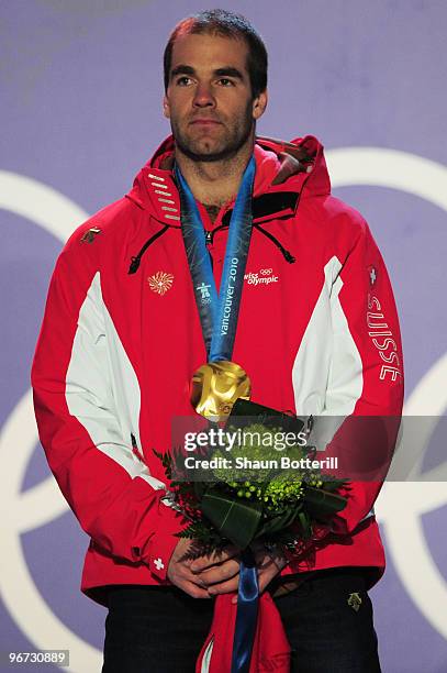 Didier Defago of Switzerland poses with the gold medal at the medal ceremony for the Alpine skiing Men's Downhill at Whistler Medal Plaza during the...