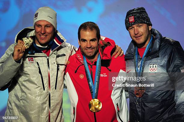 Aksel Lund Svindal of Norway celebrates winning the silver, Didier Defago of Switzerland poses with the gold and Bode Miller of the United States...