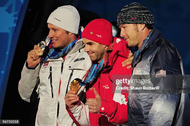 Aksel Lund Svindal of Norway celebrates winning the silver, Didier Defago of Switzerland poses with the gold and Bode Miller of the United States...