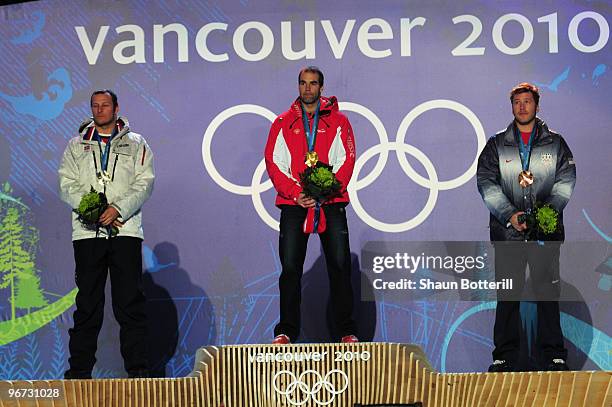 Aksel Lund Svindal of Norway celebrates winning the silver, Didier Defago of Switzerland poses with the gold and Bode Miller of the United States...