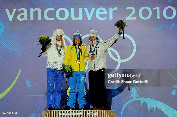 Kristina Smigun-Vaehi of Estonia poses with the silver medal, Charlotte Kalla of Sweden poses with the gold medal and Marit Bjoergen of Norway...