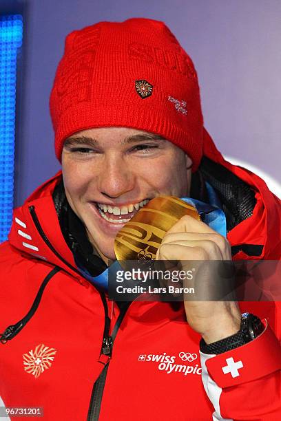 Dario Cologna of Switzerland celebrates with the gold medal during the medal ceremony for the Cross-Country Skiing Men's 15 km Free on day 4 of the...