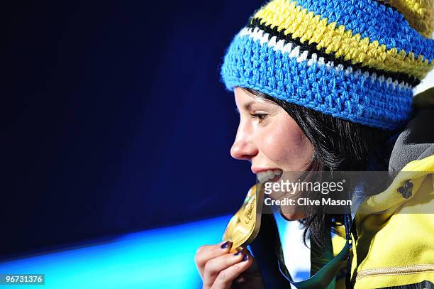 Charlotte Kalla of Sweden celebrates before receiving the gold medal during the medal ceremony for the Cross-Country Skiing Ladies' 10 km Free at...