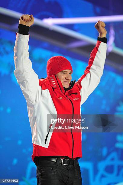 Dario Cologna of Switzerland celebrates before receiving the gold medal during the medal ceremony for the Cross-Country Skiing Men's 15 km Free on...