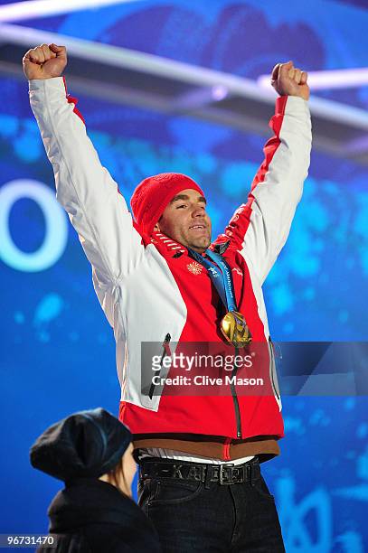 Didier Defago of Switzerland celebrates with the gold medal at the medal ceremony for the Alpine skiing Men's Downhill at Whistler Medal Plaza during...
