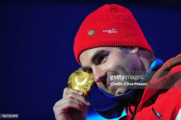 Didier Defago of Switzerland celebrates with the gold medal at the medal ceremony for the Alpine skiing Men's Downhill at Whistler Medal Plaza during...