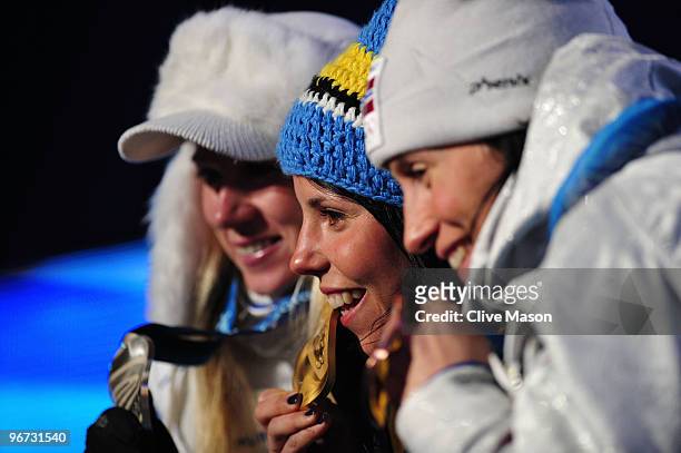 Kristina Smigun-Vaehi of Estonia poses with the silver medal, Charlotte Kalla of Sweden poses with the gold medal and Marit Bjoergen of Norway...