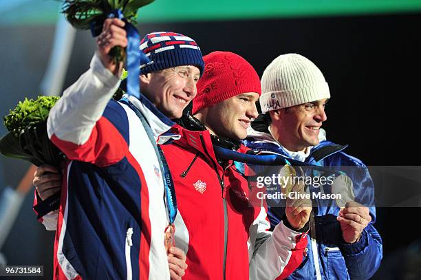 Lukas Bauer of Czech Republic celebrates with the bronze, Dario Cologna of Switzerland celebrates with the gold and Pietro Piller Cottrer of Italy...