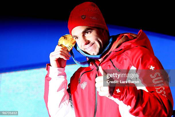 Didier Defago of Switzerland celebrates with the gold medal at the medal ceremony for the Alpine skiing Men's Downhill at Whistler Medal Plaza during...