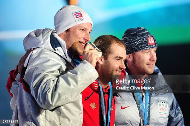 Aksel Lund Svindal of Norway celebrates winning the silver, Didier Defago of Switzerland poses with the gold and Bode Miller of the United States...