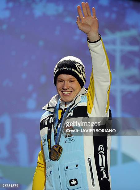 German gold medallist Felix Loch stands on the podium during the medal ceremony for the Luge Men's single event of the Vancouver 2010 Winter Olympics...