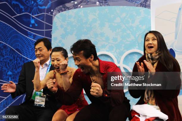 Xue Shen and Hongbo Zhao of China react in the kiss and cry area after they competed in the figure skating pairs free skating on day 4 of the...