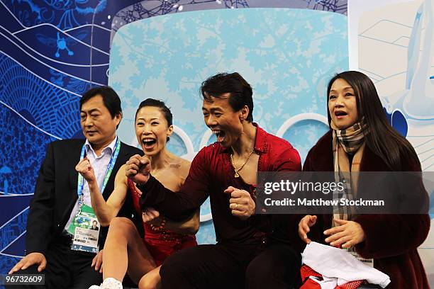 Xue Shen and Hongbo Zhao of China react in the kiss and cry area after they competed in the figure skating pairs free skating on day 4 of the...