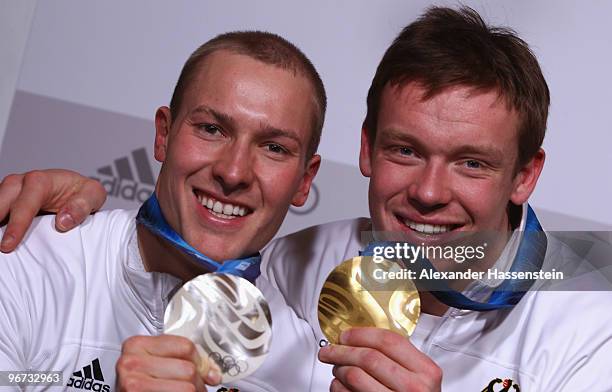 David Moeller of Germany celebrates with the silver medal and his teammate Felix Loch with his gold medal for their men's luge singles at the German...