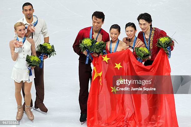 Aliona Savchenko and Robin Szolkowy of Germany win the bronze medal, Hongbo Zhao and Xue Shen of China win the gold medal, and Qing Pang and Jian...