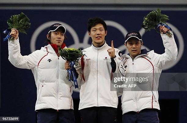 Gold medal winner South Korea's Mo Tae-Bum , silver Medalist Japan's Keiichiro Nagashima and bronze medal winner Japan's Joji Kato celebrate victory...