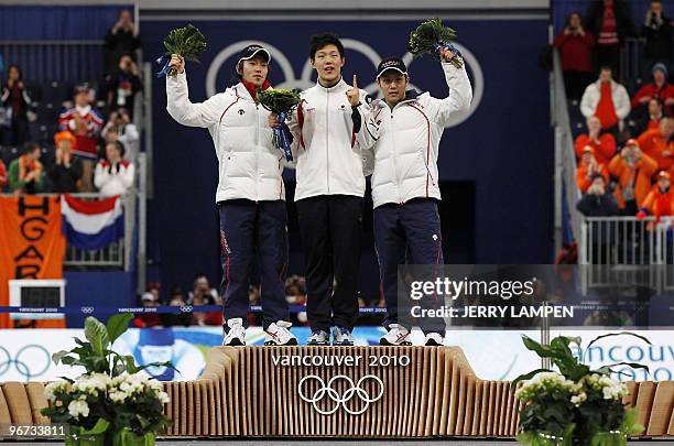 Gold medal winner South Korea's Mo Tae-Bum , silver Medalist Japan's Keiichiro Nagashima and bronze medal winner Japan's Joji Kato celebrate victory...