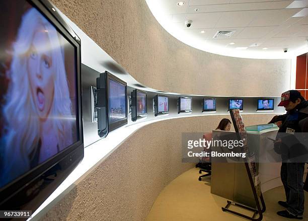Television monitors are displayed in the reception area of Jupiter Telecommunications Co.'s headquarters in Tokyo, Japan, on Tuesday, Feb. 16, 2010....