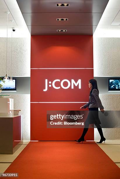 An employee of Jupiter Telecommunications Co. Walks through the reception area of the company's headquarters in Tokyo, Japan, on Tuesday, Feb. 16,...