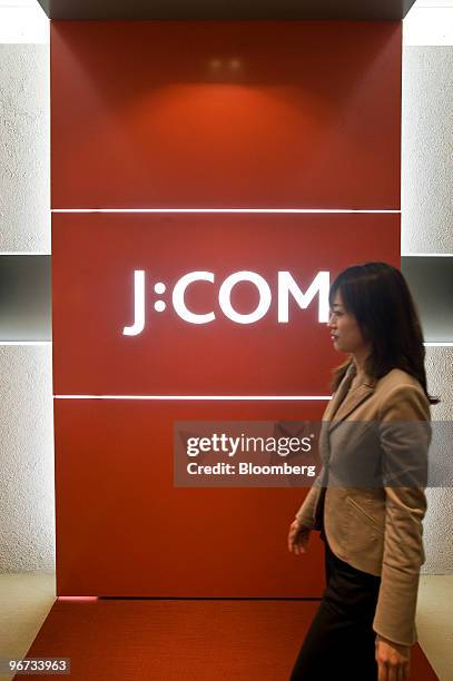 An employee of Jupiter Telecommunications Co. Walks through the reception area of the company's headquarters in Tokyo, Japan, on Tuesday, Feb. 16,...