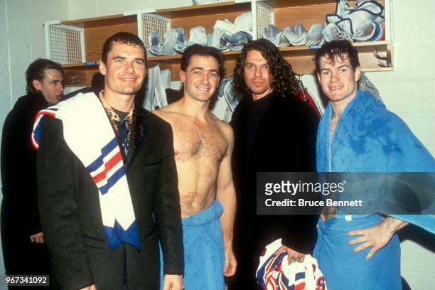 Goalies John Vanbiesbrouck and Mike Richter of the New York Rangers pose with Jon Farriss and Michael Hutchence of the music group INXS after an NHL...