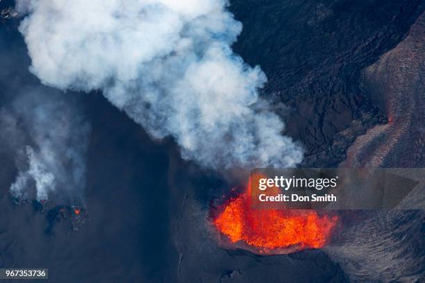 An aerial view of Fissure 8 Fountain, which is located inside Leilani Estates, spews molten lava on June 1, 2018 in Pahoa, Hawaii. Lava was estimated...