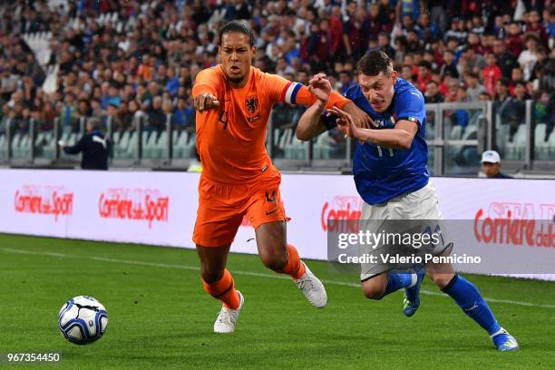 Andrea Belotti of Italy competes for the ball with Virgil Van Dijk of Netherlands during the International Friendly match between Italy and...