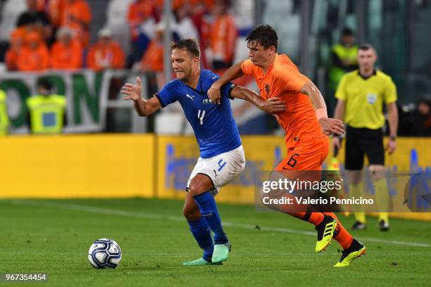 Domenico Criscito of Italy competes for the ball with Marten De Roon of Netherlands during the International Friendly match between Italy and...