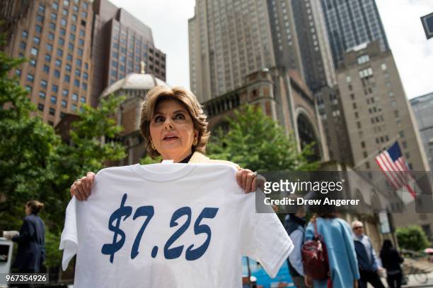 Attorney Gloria Allred holds a t-shirt that reads '$7.25' as she arrives for a press conference about the low pay and treatment of former Houston...