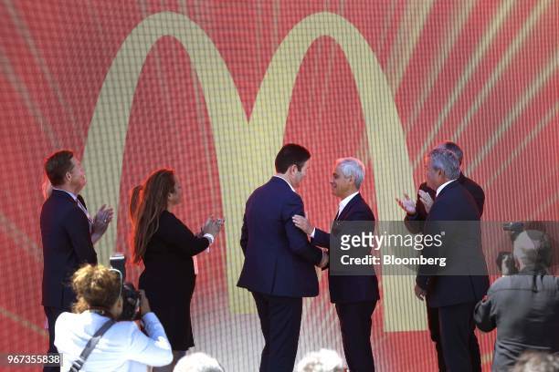 Steve Easterbrook, chief executive officer of McDonald's Corp., center left, shakes hands with Rahm Emanuel, mayor of Chicago, center right, during...