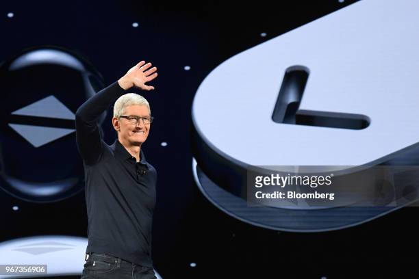 Tim Cook, chief executive officer of Apple Inc., waves while arriving on stage during the Apple Worldwide Developers Conference in San Jose,...