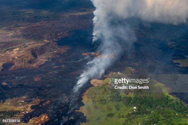 Lava from the Kilauea Volcano burns trees near a Geothermal Plant along the East Rift Zone which runs through Leilani Estates on the Big Island on...