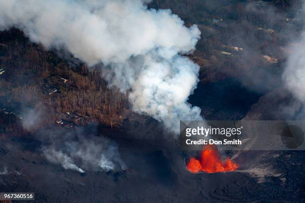 An aerial view of Fissure 8 Fountain, which is located inside Leilani Estates, spews molten lava on June 1, 2018 in Pahoa, Hawaii. Lava was estimated...