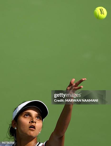 India's Sania Mirza serves to Spain's Anabel Medina Garrigues during their WTA Dubai Tennis Championships first round match in the Gulf emirate on...