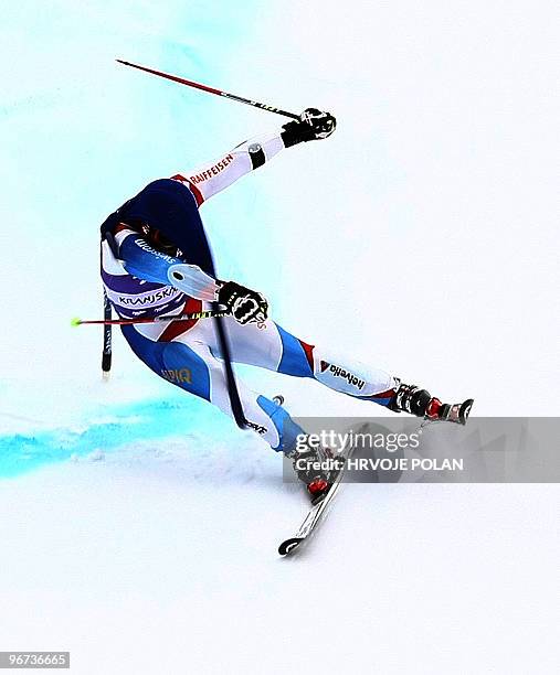 Suiss' Didier Cuche hits the gate just few meters before the finish area and then fell, not to finish the giant slalom in Kranjska Gora on January...