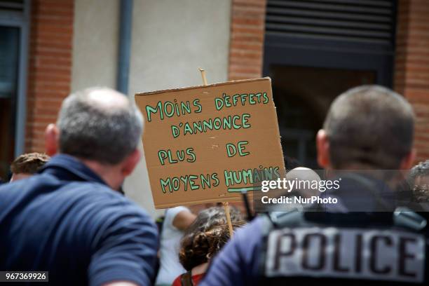 Teacher shows a placard reading 'Less announcement effects, more human means' near riot policemen. Primary school teachers and parents'pupils...