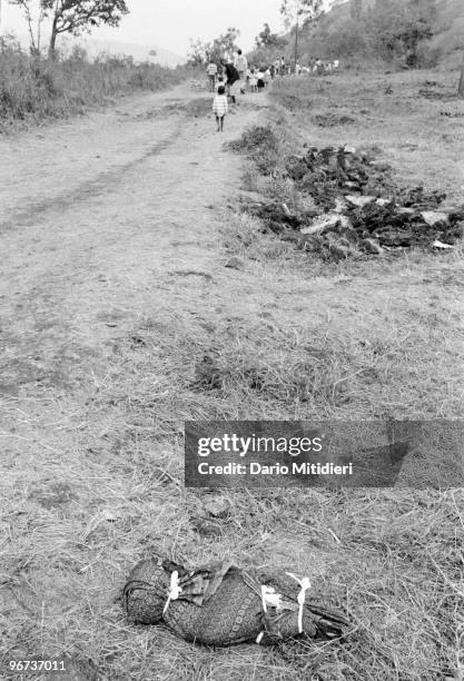 The body of a child who survived the 1994 Rwandan genocide, but later died following a deadly outbreak of cholera, is left for collection on the side...